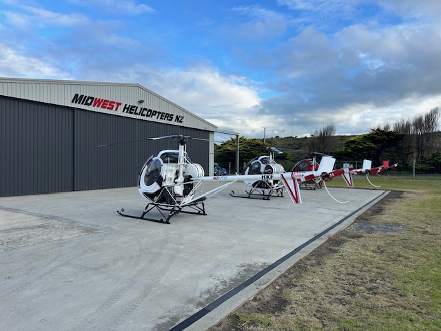 Schweizer 269 helicopters on the apron Wanganui